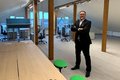 Harald Vieten steht zwischen den Balken des modernisierten Dachgeschoss-Großraumbüros mit schrägen Wänden. 
