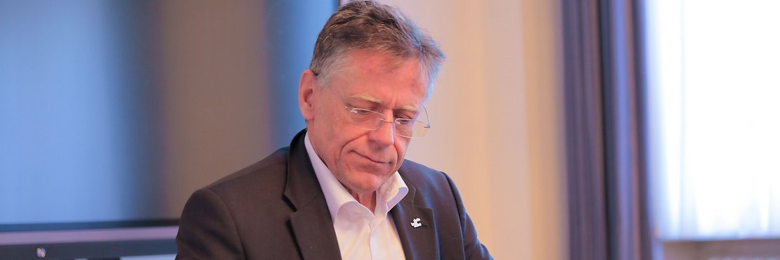 Landrat Hans-Jürgen Petrauschke arbeitend an einem Schreibtisch