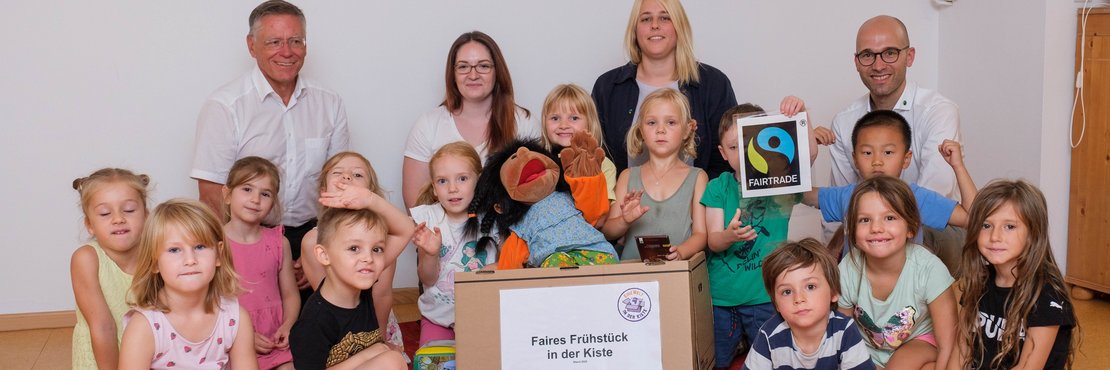 Foto von Landrat Hans-Jürgen Petrauschke (l.) mit Sabrina Katzmann (2.v.l. hinten), Leiterin des Familienzentrums Regenbogen, der stellvertretenden Leiterin Katharina Esch (2.v.r. hinten), Kreissprecher Benjamin Josephs (r.) und den Vorschulkindern