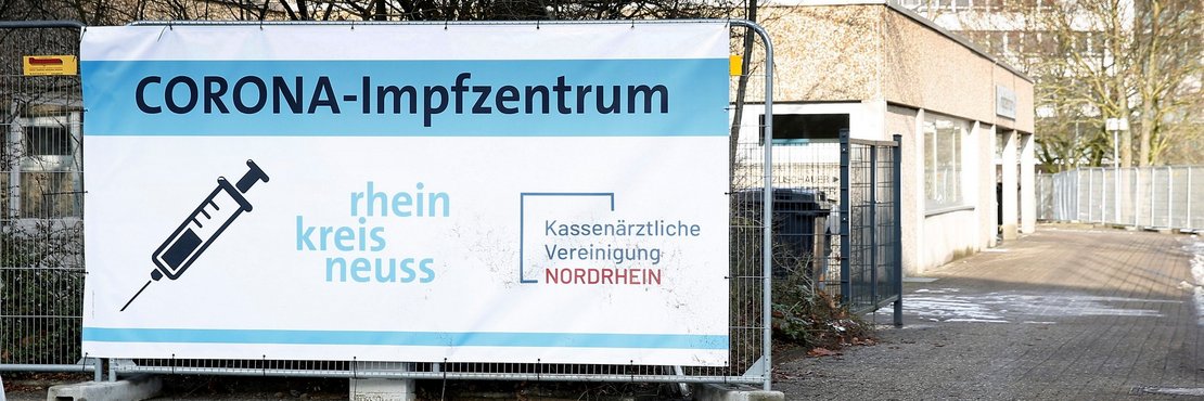 Banner vor Impfzentrum: "Corona Impfzentrum Rhein-Kreis Neuss"