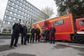 uniformierte und ziviel gekleidete Mitarbeitende der Kreisleitstelle vor dem Einsatzleitwagen-2, der vor dem Kreishochhaus in Grevenbroich steht