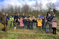 Landrat Hans-Jürgen Petrauschke mit einer Gruppe Grundschulkinder und Lehrern, die Spaten in die Höhe halten.