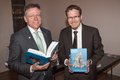 Landrat Hans Jürgen Petrauschke und Dr. Stephen Schröder mit Buch in der Hand