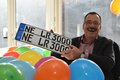 Bunte Luftballons im Vordergrund. Dahinter Michael Rönicke lachend, mit den Nummernschildern seines Dienstwagens: "NE LR 3000"