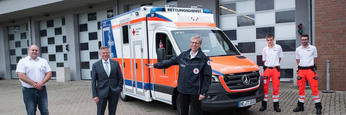 Landrat Hans-Jürgen Petrauschke Marcel Engel, Marc Dietrich, Fionn Bischoffs und Julian Gräve vor einem Rettungswagen