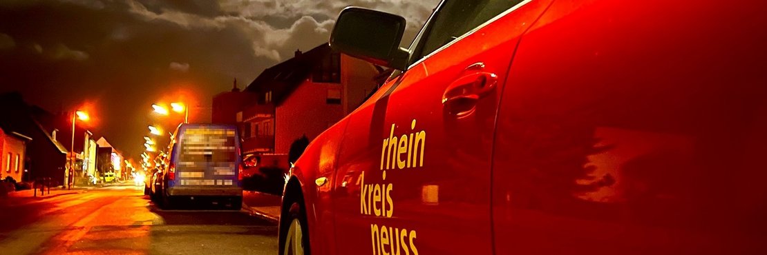 Feuerwehrauto mit Aufschrift "Rhein-Kreis Neuss" in einem Gewitter