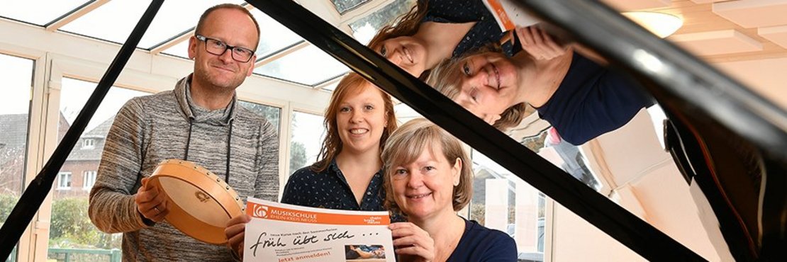 Markus Wehner, Juliane Ries und Ruth Braun-Sauerwein sitzen an einem Klavier und zeigen einen Flyer