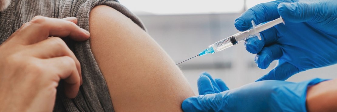 Symbolbild: Impfsprizte verabreicht Impfstoff in Oberarm